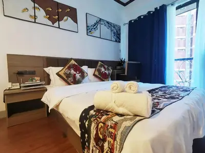 a bedroom with a bed with two towels on it at warm makati in Manila