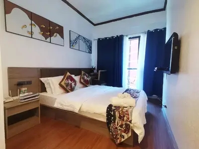 a bedroom with a bed and a television and a chair at warm makati in Manila