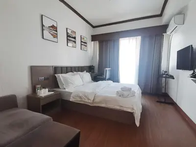 a hotel room with a bed and a couch at passion makati in Manila