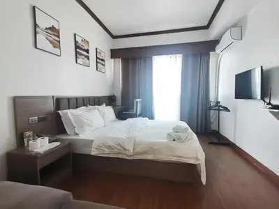 a hotel room with a bed and a window at passion makati in Manila