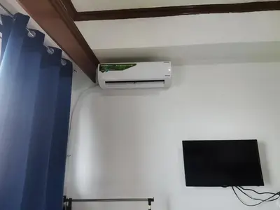 a room with a wall with a tv on a wall at passion makati in Manila