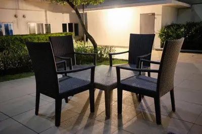 a group of chairs sitting on a patio at Sea Residences - Classy Unit Near Mall of Asia, Arena, Ayala, Ikea, Okada, SMX, PITX, Airport in Manila