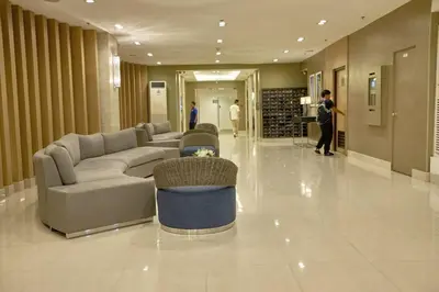 a lobby with a couch and chairs in a building at Sea Residences - Classy Unit Near Mall of Asia, Arena, Ayala, Ikea, Okada, SMX, PITX, Airport in Manila