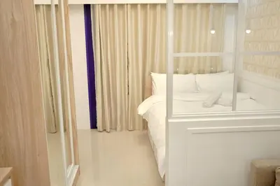 a bedroom with a white bed and a window at Sea Residences - Classy Unit Near Mall of Asia, Arena, Ayala, Ikea, Okada, SMX, PITX, Airport in Manila