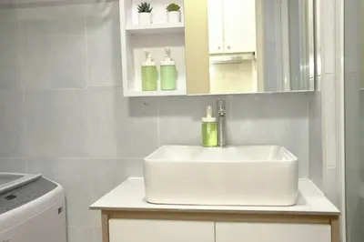 a bathroom with a white sink and a washing machine at Sea Residences - Classy Unit Near Mall of Asia, Arena, Ayala, Ikea, Okada, SMX, PITX, Airport in Manila