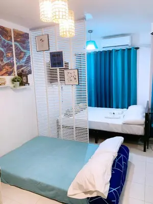 a room with a bed and a room with two beds at Blue Diamond Staycation beside Enchanted Kingdom in Santa Rosa Laguna in Santa Rosa