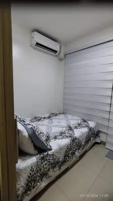 a bedroom with a bed and a window with a heater at Shore 2 Tower 1 JMB Staycation in Manila