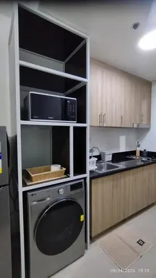 a kitchen with a stove and a microwave at Shore 2 Tower 1 JMB Staycation in Manila