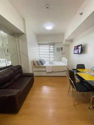 a living room with a couch and a bed at Condo near UP-PGH, St. Lukes Medical Center and U.S Embassy in Ermita Manila in Manila