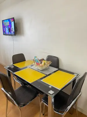 a dining room table with chairs and a bowl on it at Condo near UP-PGH, St. Lukes Medical Center and U.S Embassy in Ermita Manila in Manila