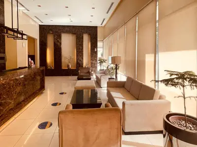 a lobby with a couch and chairs and a table at Condo near UP-PGH, St. Lukes Medical Center and U.S Embassy in Ermita Manila in Manila