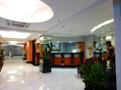 a lobby with a waiting area with plants in it at Silver Oaks Suites & Hotel in Manila