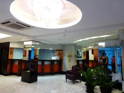 a lobby with a chandelier and a waiting room at Silver Oaks Suites & Hotel in Manila