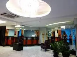 a lobby with a waiting room with chairs and a ceiling at Silver Oaks Suites & Hotel in Manila