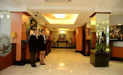 two people standing in a hallway in a hotel at Silver Oaks Suites & Hotel in Manila