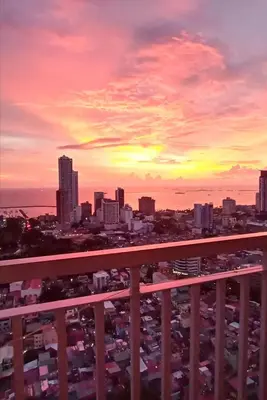 a view of a city skyline at sunset at The SCENIC: Comfortable living by Awsom Phil in Manila