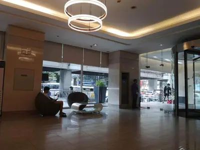 a man sitting in a chair in a lobby at The SCENIC: Comfortable living by Awsom Phil in Manila