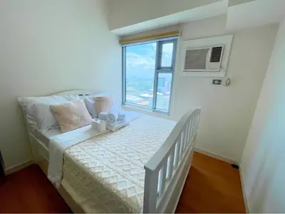 a small bedroom with a bed and a window at Condo for Short Stay in Ermita near SLMEC & US Embassy in Manila