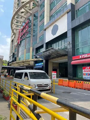 a van parked in front of a building at Condo for Short Stay in Ermita near SLMEC & US Embassy in Manila