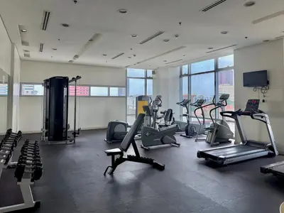 a gym with treadmills and cardio equipment in a building at Condo for Short Stay in Ermita near SLMEC & US Embassy in Manila