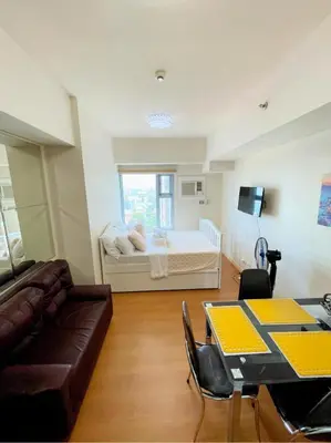 a living room with a couch and a bed at Condo for Short Stay in Ermita near SLMEC & US Embassy in Manila