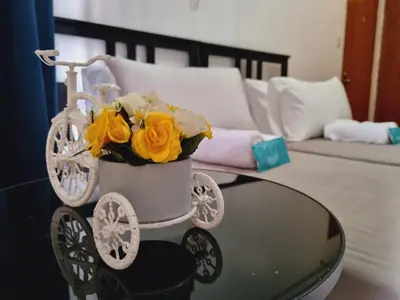 a vase of flowers sitting on a glass table at Newport's STAR at Montecito Residential Resort in Manila