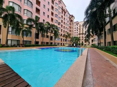 a large blue swimming pool in front of buildings at Newport's STAR at Montecito Residential Resort in Manila