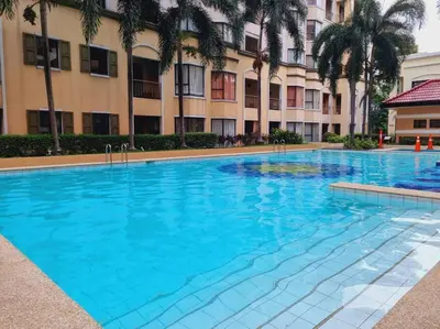 a large blue swimming pool in front of a building at Newport's STAR at Montecito Residential Resort in Manila