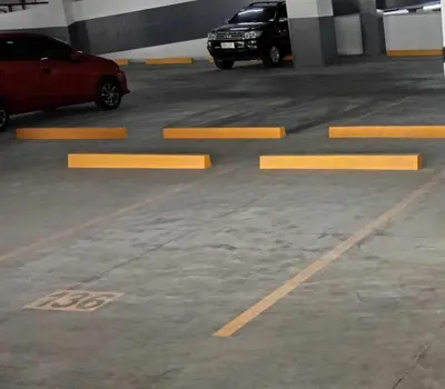 two cars parked in a parking garage with yellow lines at The ICONIC: Comfortable living by Awsom Phil in Manila