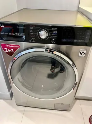 a washing machine with its door open in a room at Luxury Studio in heart of Ortigas w/ swimming pool in Manila