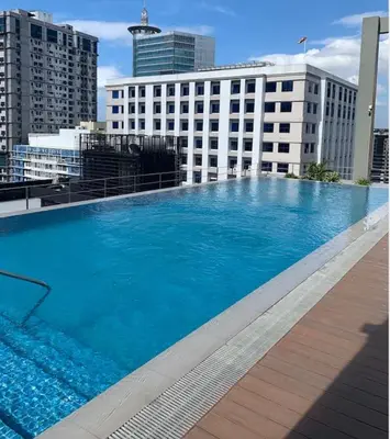 a large swimming pool on the roof of a building at 3BR luxury apartment in Ortigas with swimming pool in Manila