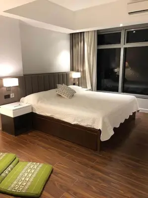 a bedroom with a large bed and a window at 3BR luxury apartment in Ortigas with swimming pool in Manila
