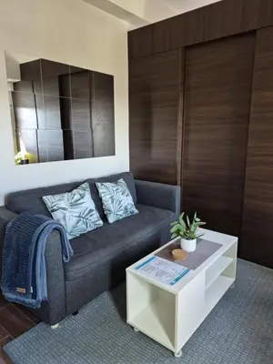a living room with a couch and a coffee table at Air Residences Makati - fully furnished condo with skyline views! in Manila
