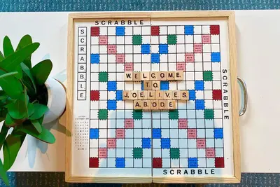 a board game in a wooden frame next to a plant at Air Residences Makati - fully furnished condo with skyline views! in Manila