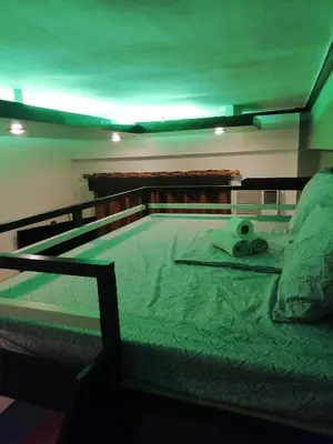 a bed with a pair of scissors on it at Condo near NAIA Terminals Fasanvej Studio Netflix in Manila