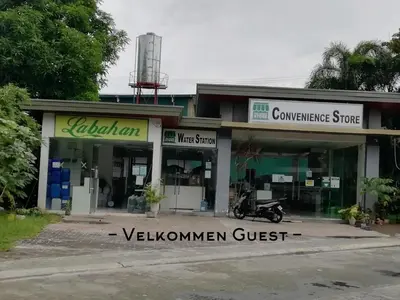 a store with a motorcycle parked in front of it at Condo near NAIA Terminals Fasanvej Studio Netflix in Manila