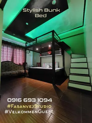 a bedroom with a bunk bed with a green ceiling at Condo near NAIA Terminals Fasanvej Studio Netflix in Manila