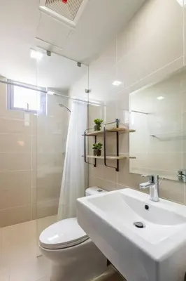 a white bathroom with a toilet and a sink at Luxury living @ Eastwood in Manila