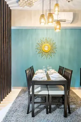 a dining room with a table and four chairs at Luxury living @ Eastwood in Manila