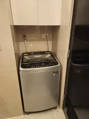 a kitchen with a stove and a refrigerator at 81 Newport C5 10i Balcony & Pool across NAIA T3 in Manila
