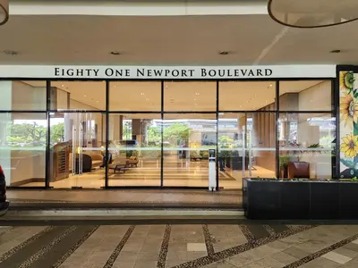 a building with a sign that reads eighty one newport boulevard at 81 Newport C5 10i Balcony & Pool across NAIA T3 in Manila