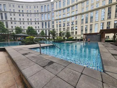 a swimming pool in front of a large building at 81 Newport C5 10i Balcony & Pool across NAIA T3 in Manila