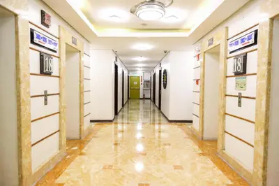 a corridor of a hospital with doors and tile floors at Pacific Bay Grand Suites in Manila