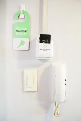 a wall with a phone and a box on a wall at Pacific Bay Grand Suites in Manila