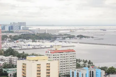 an aerial view of a city and a body of water at Pacific Bay Grand Suites in Manila