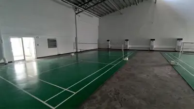 an empty gym with a green tennis court at Stunning 1-Bedroom Condo in Manila