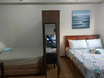 a bedroom with a bed and a mirror at Happy Stays A - 300mbps - 65