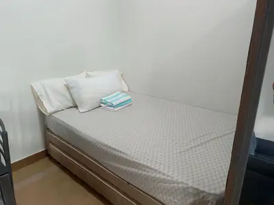 a bed with two pillows on it in a room at Happy Stays A - 300mbps - 65