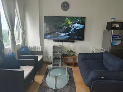 a living room with two couches and a flat screen tv at Happy Stays A - 300mbps - 65