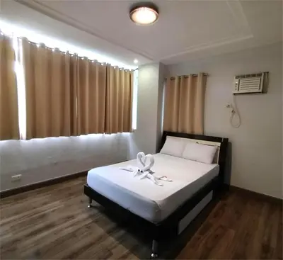 a bedroom with a bed and a window at SULIT CONDO Unit 2 Santa Mesa Manila in Manila